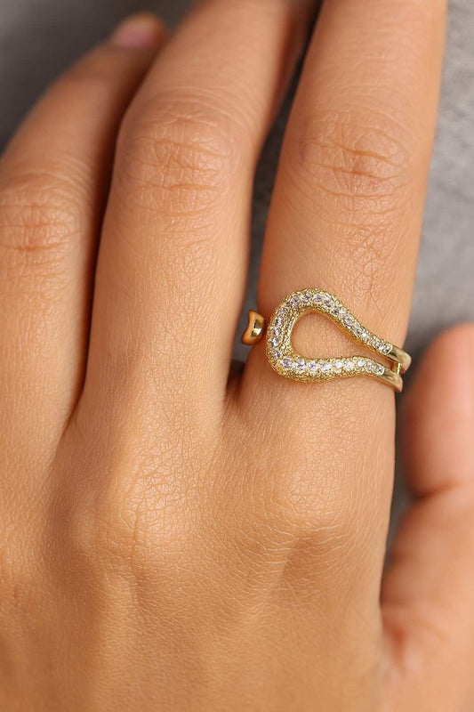 "Model wearing gold-tone open teardrop crystal ring with adjustable fit"

