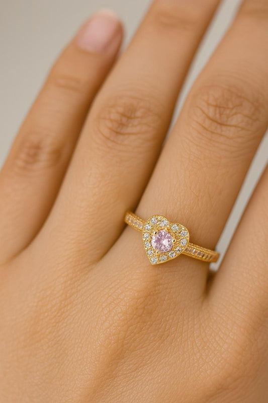 "Model wearing gold-tone pink heart crystal ring with adjustable fit"