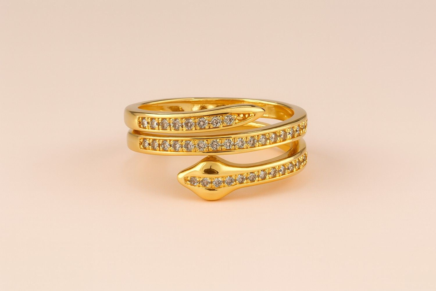 "Model wearing gold-tone snake wrap ring with crystal-studded design"
