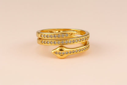"Model wearing gold-tone snake wrap ring with crystal-studded design"