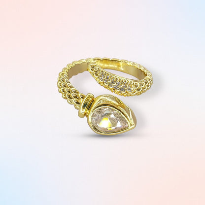 "Gold-tone textured band ring with teardrop stone and crystal accents"