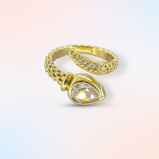 "Gold-tone textured band ring with teardrop stone and crystal accents"