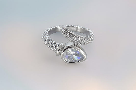 "Silver-tone textured band ring with teardrop stone and crystal accents"