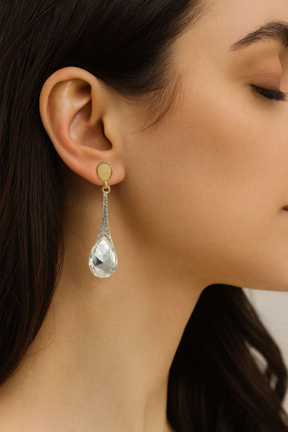 Model wearing golden finish drop earrings with clear teardrop crystal – side view

