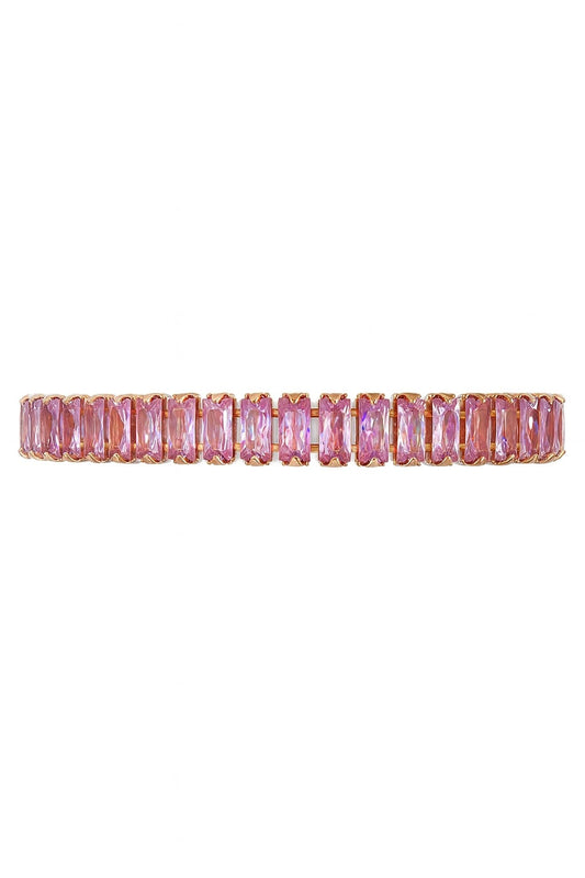 Pink baguette tennis bracelet in rose gold-tone setting on white background