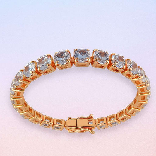 Cushion-cut crystal tennis bracelet in rose gold-tone setting on gradient background