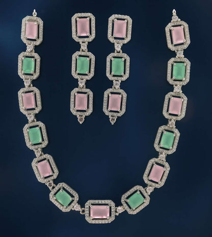 Pink and green American Diamond necklace set with earrings in silver-tone finish on dark background