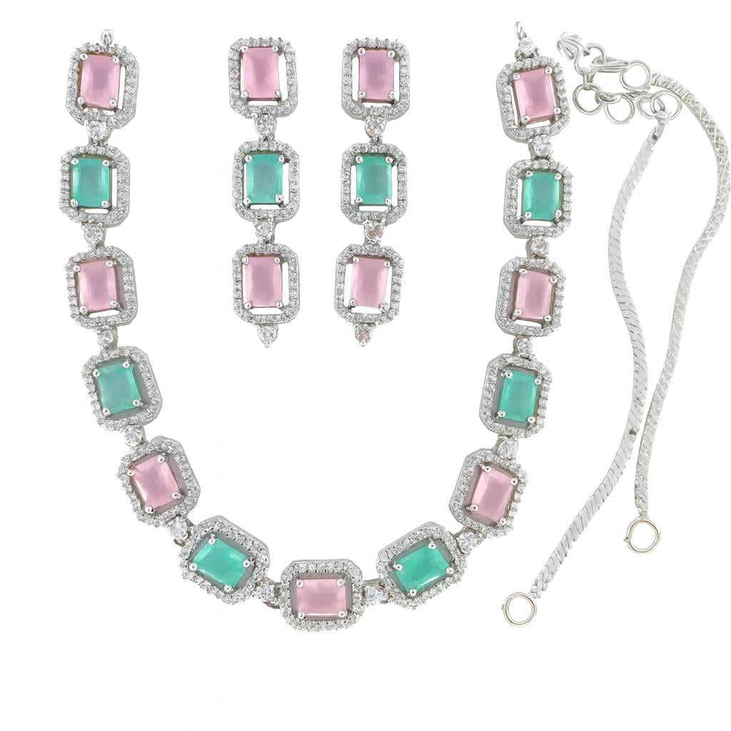 Pink and green American Diamond necklace set with earrings in silver-tone finish on white background

