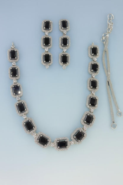 Black American Diamond necklace set with earrings in silver-tone finish on light blue background