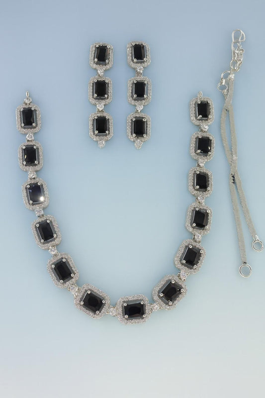 Black American Diamond necklace set with earrings in silver-tone finish on light blue background