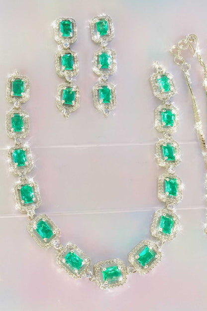 Green American Diamond necklace set with earrings in silver-tone finish on light background