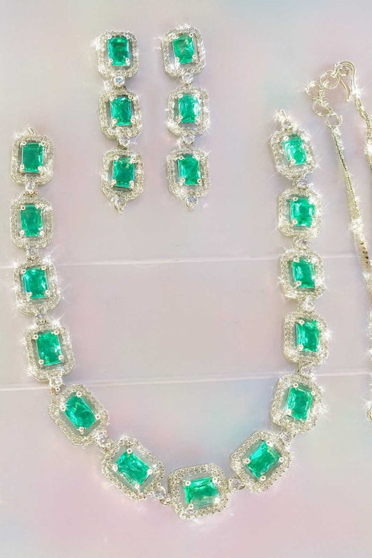 Green American Diamond necklace set with earrings in silver-tone finish on light background