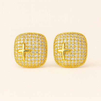 Model wearing gold-tone crystal cross stud earrings