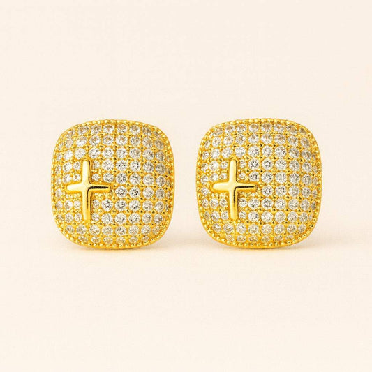 Model wearing gold-tone crystal cross stud earrings