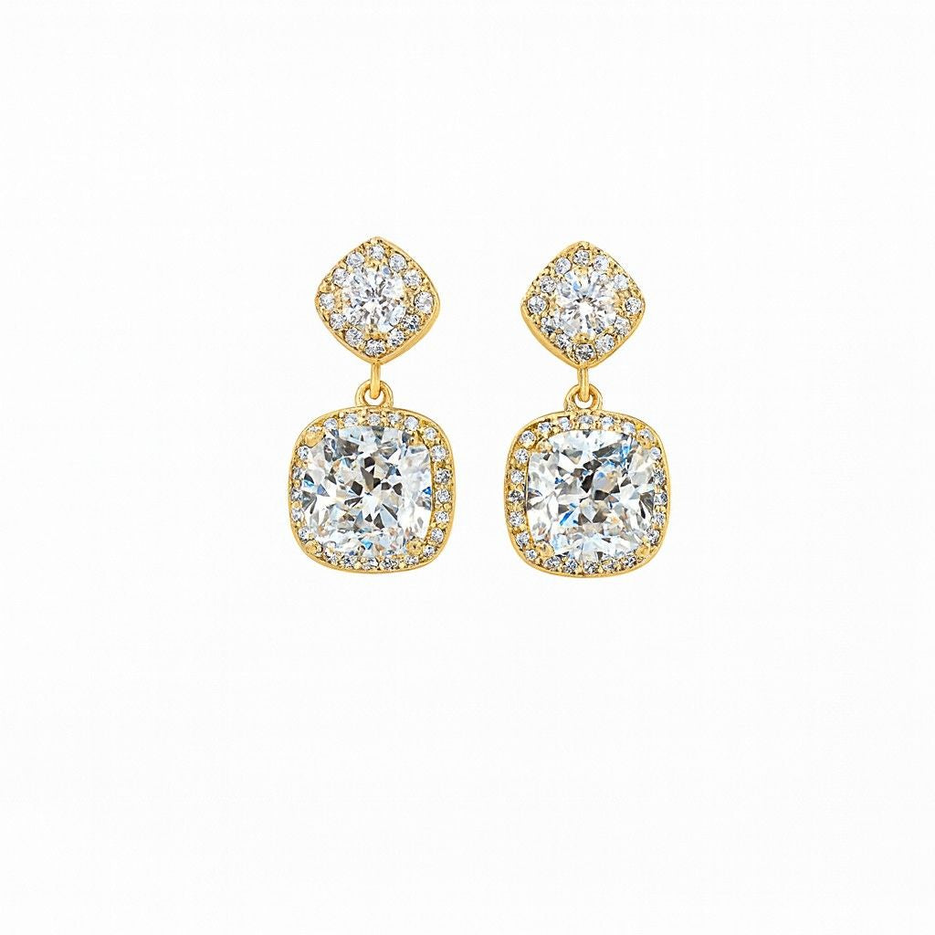 Pair of gold-tone cushion cut crystal drop earrings on white background