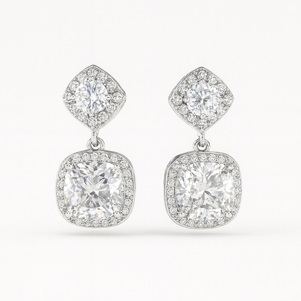 Pair of luxury silver-tone cushion cut crystal drop earrings on white background