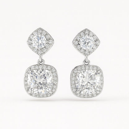 Pair of luxury silver-tone cushion cut crystal drop earrings on white background