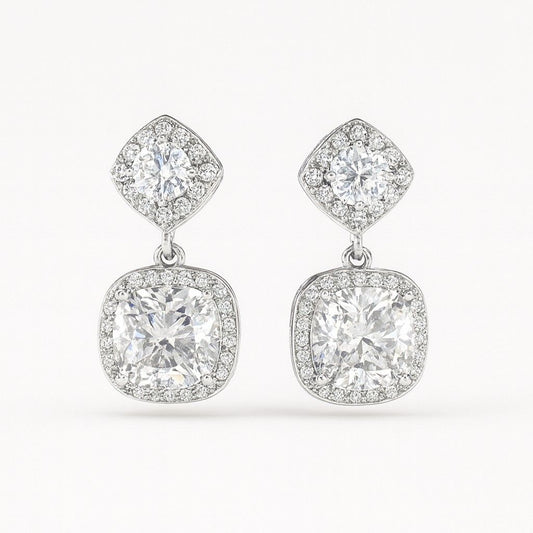 Pair of luxury silver-tone cushion cut crystal drop earrings on white background
