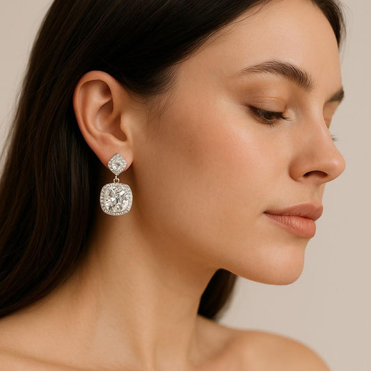 Model wearing silver-tone cushion cut crystal drop earrings