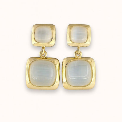 Pair of elegant gold-tone dual square drop earrings on beige background