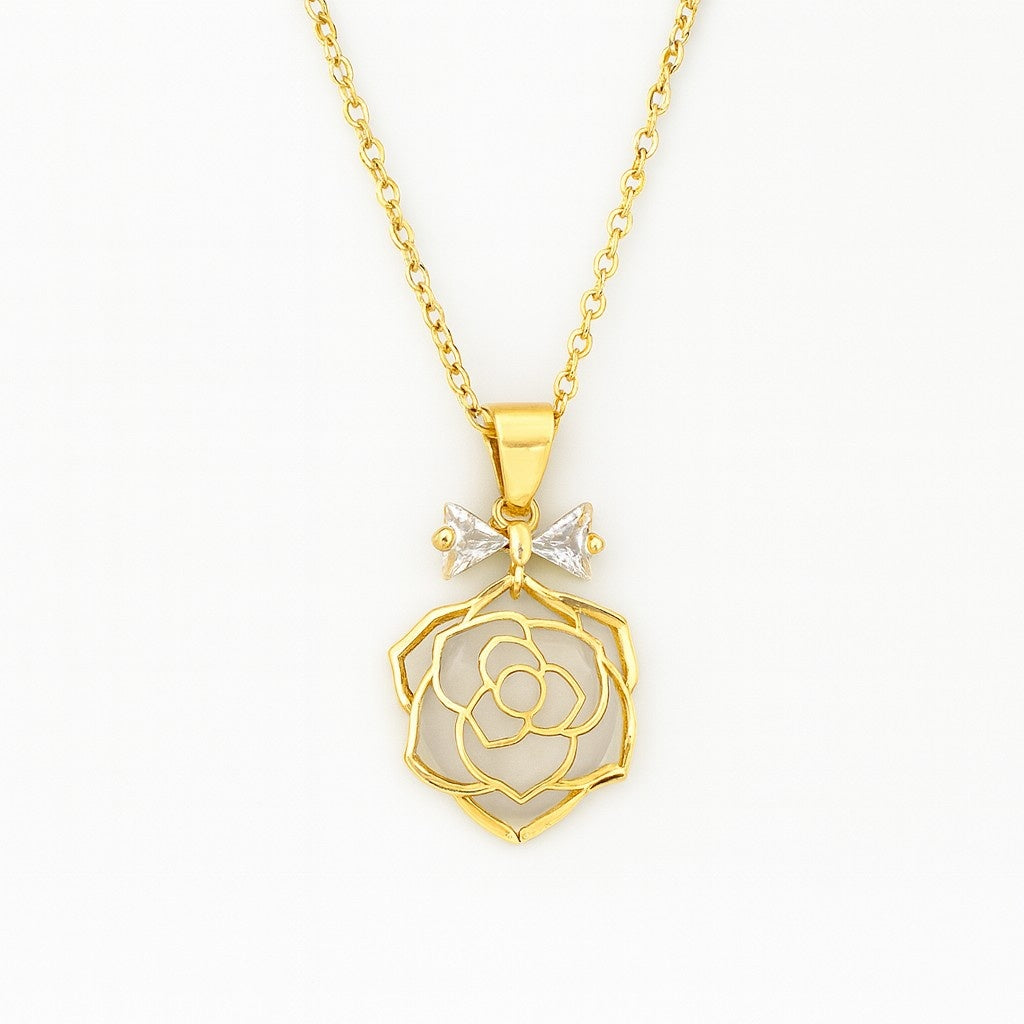 Gold-tone rose pendant necklace with crystal bow accent