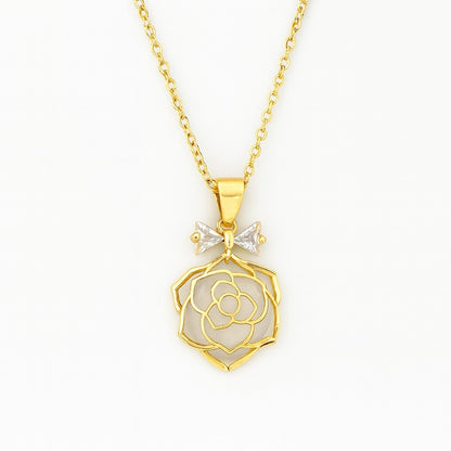 Gold-tone rose pendant necklace with crystal bow accent