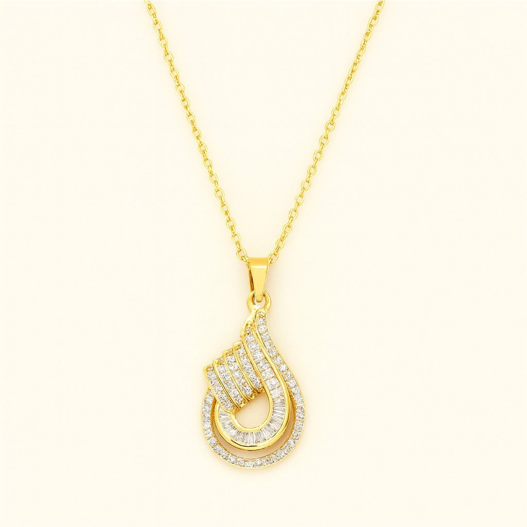 Gold-tone teardrop crystal pendant necklace with intricate detailing