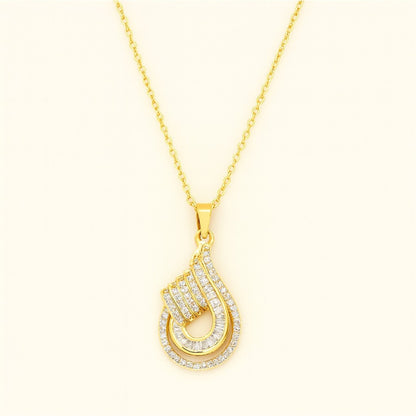 Gold-tone teardrop crystal pendant necklace with intricate detailing